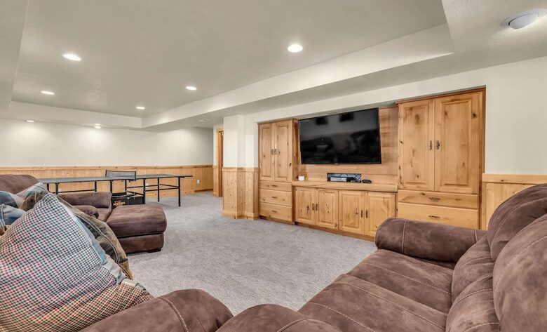 Basement with TV and ping pong table