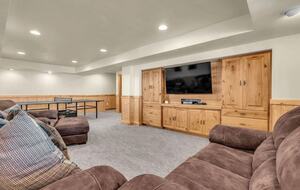 Basement with TV and ping pong table