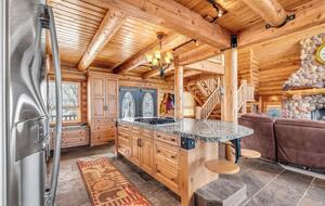 Kitchen island has stool seating for 5