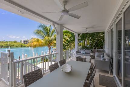 Living room balcony with dining table and couches