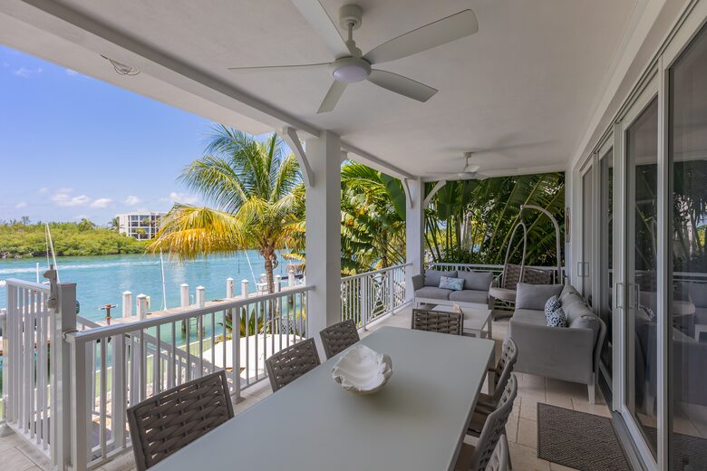 Living room balcony with dining table and couches