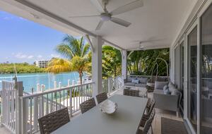 Living room balcony with dining table and couches