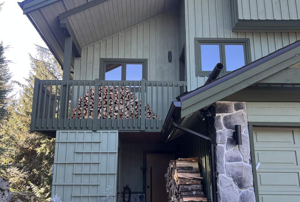 Exterior of house with north facing deck and garage.