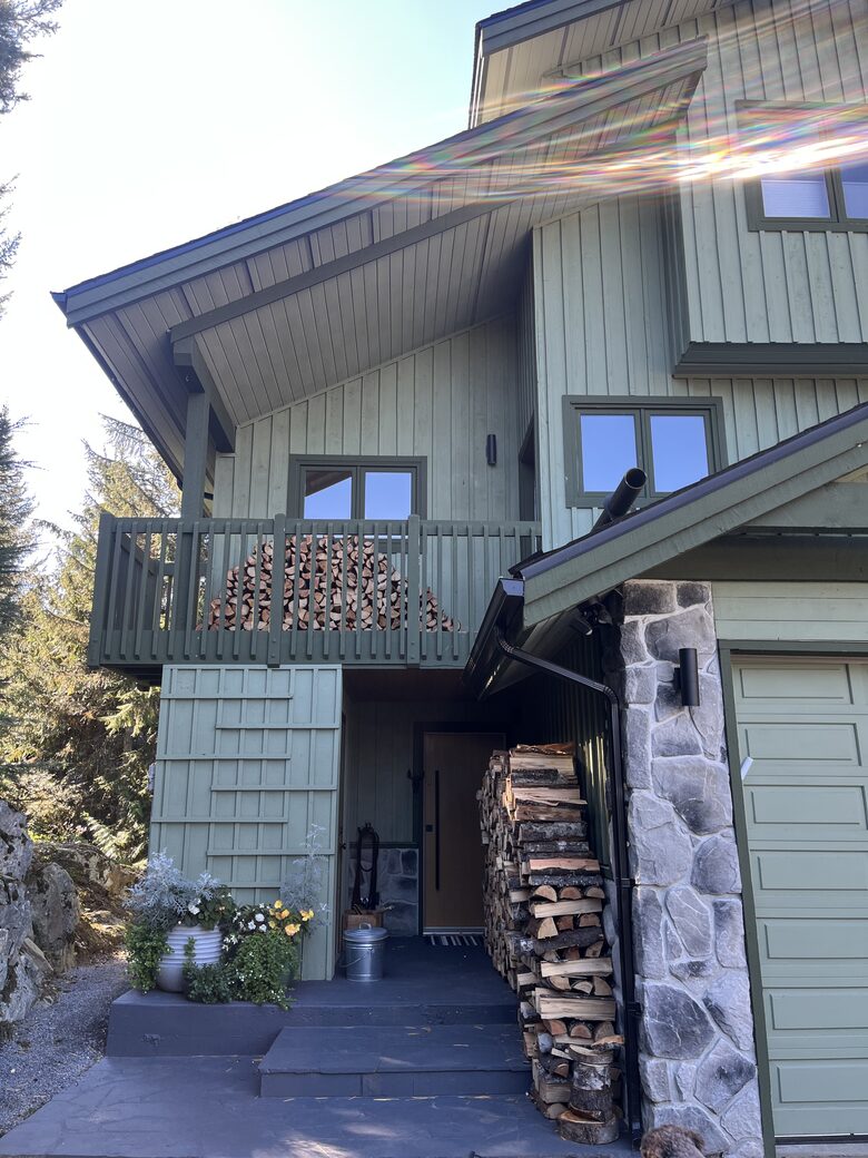 Exterior of house with north facing deck and garage.
