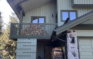 Exterior of house with north facing deck and garage.