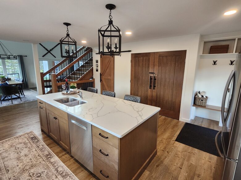 Kitchen with view of stairs and dining table.