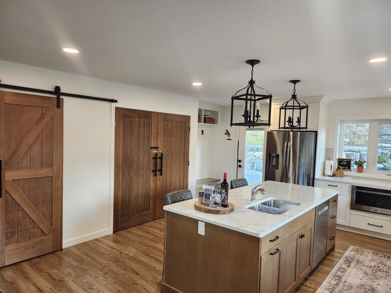 Kitchen with view of pantry and back door.