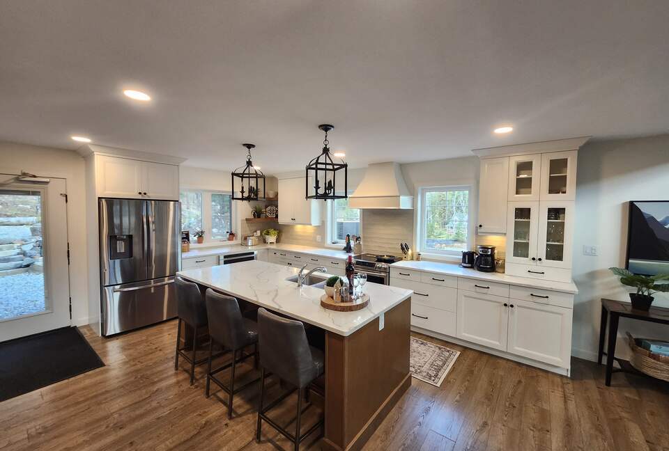 Kitchen and door to backyard, hot tub, fire pit, forest.
