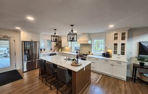 Kitchen and door to backyard, hot tub, fire pit, forest.