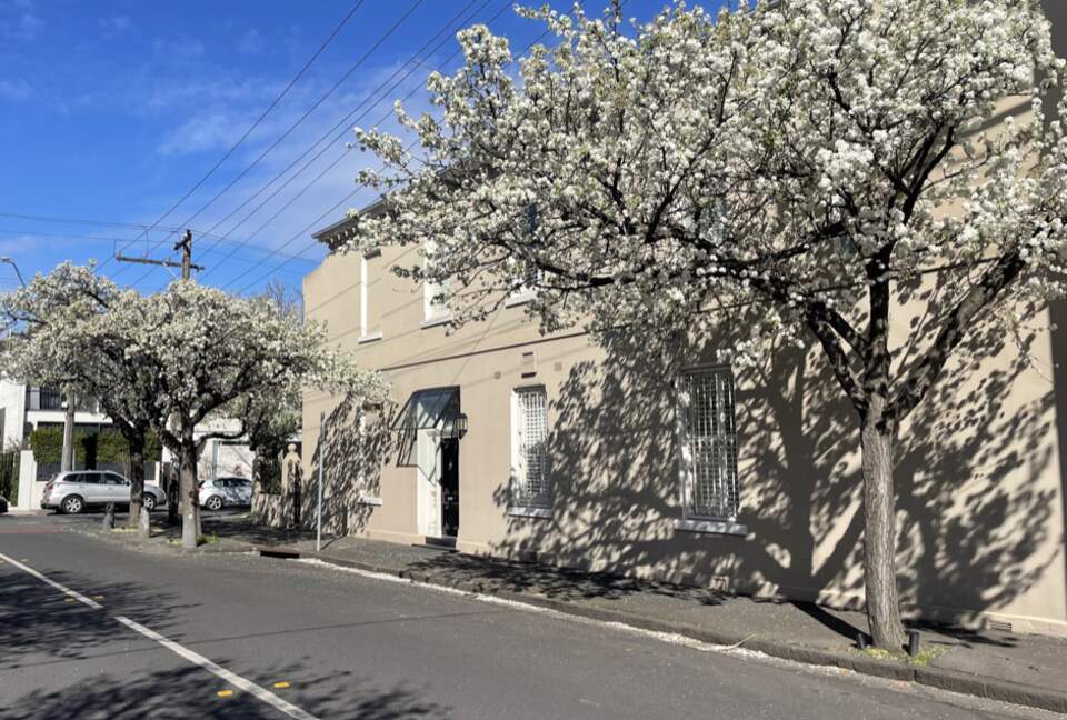 Corner home with stylish black door canopied entrance.