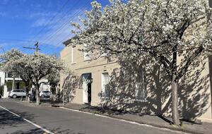 Corner home with stylish black door canopied entrance.