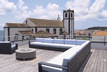 Rooftop Deck with Seating Area and Views of Ocean and Historic Church