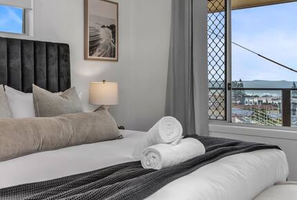 Bright bedroom with clean towels ready for guests