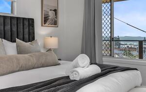 Bright bedroom with clean towels ready for guests