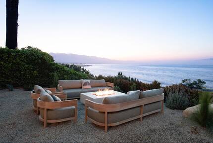 lounge area with fire pit at dusk