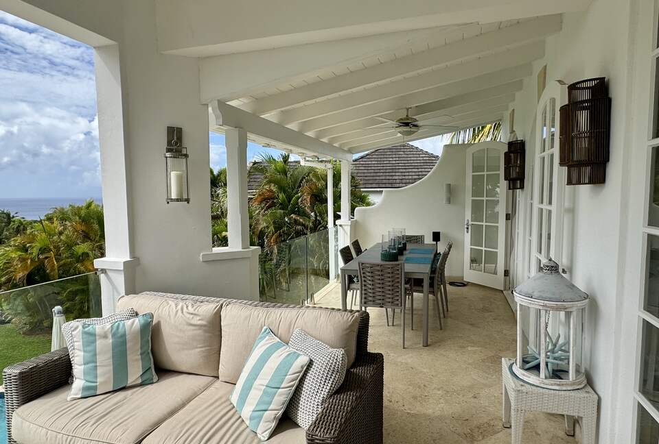 Outdoor living and dining area with Caribbean Sea views