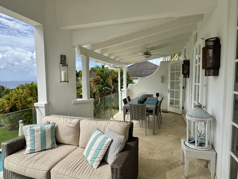 Outdoor living and dining area with Caribbean Sea views