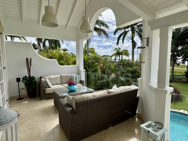 Outdoor living area with sunset views over the Caribbean Sea
