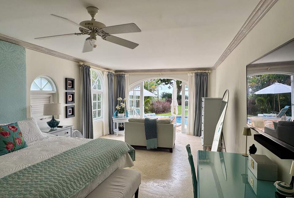 Main bedroom with living area and pool access